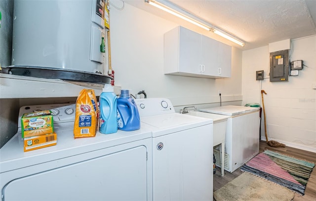 laundry area featuring light wood-type flooring, electric panel, independent washer and dryer, cabinets, and a textured ceiling