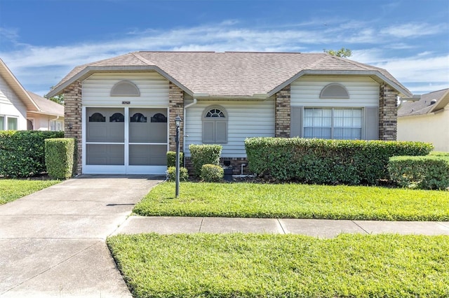 view of front of property featuring a garage and a front yard