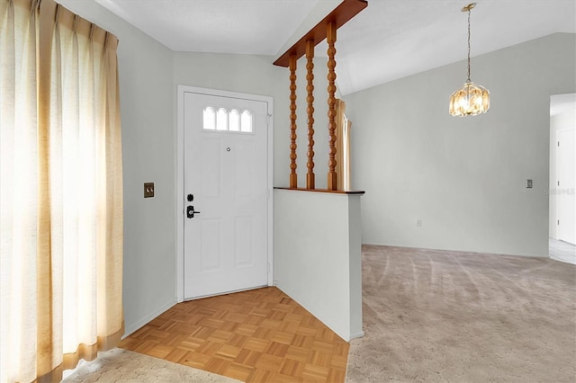 foyer featuring vaulted ceiling, a chandelier, and light parquet flooring