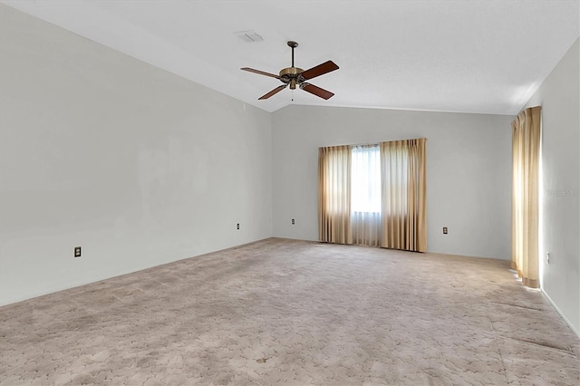 spare room with carpet floors, ceiling fan, visible vents, and vaulted ceiling