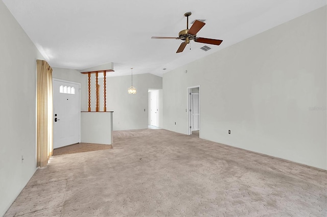 unfurnished living room with a ceiling fan, lofted ceiling, visible vents, and carpet