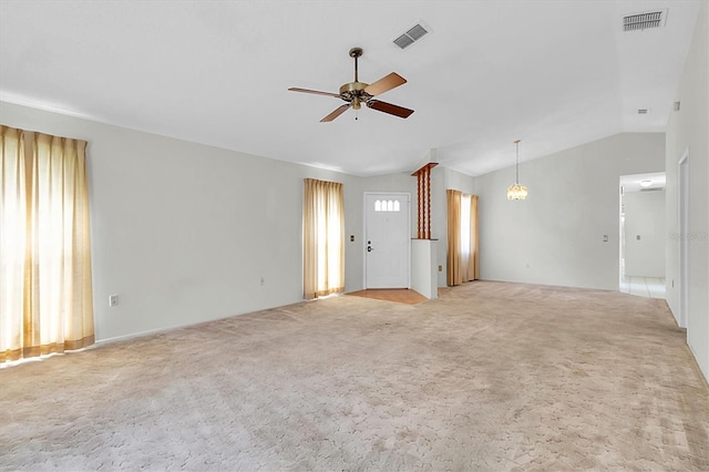 unfurnished living room with lofted ceiling, visible vents, ceiling fan, and light carpet