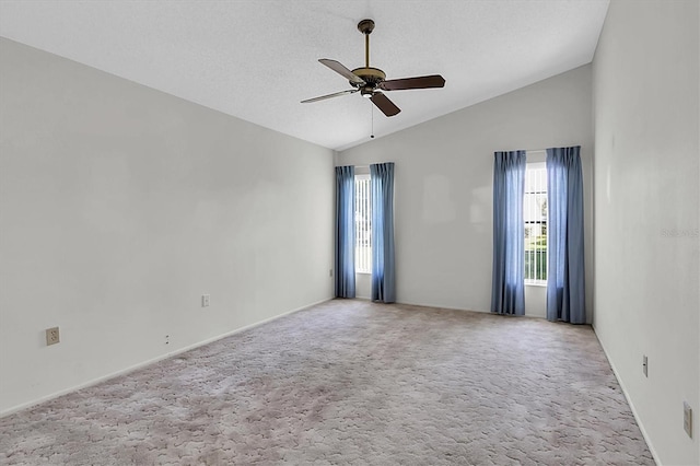 carpeted empty room featuring lofted ceiling and ceiling fan