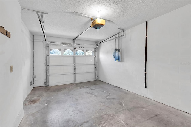 garage with electric panel and a garage door opener