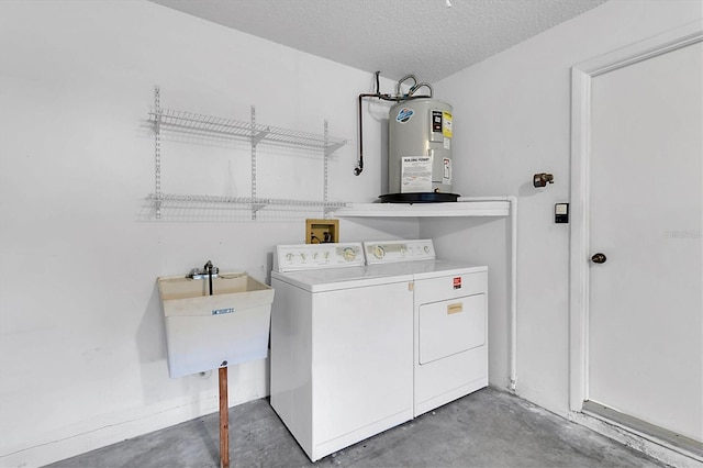 laundry area featuring a textured ceiling, washing machine and dryer, sink, and electric water heater