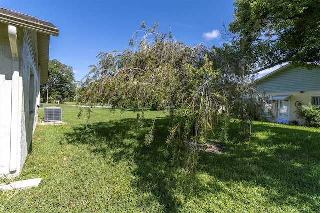 view of yard featuring central air condition unit