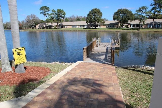 view of dock featuring a water view and a residential view