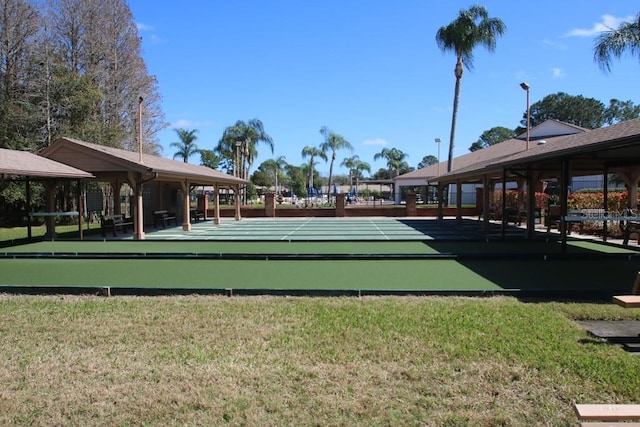 view of community featuring a yard and shuffleboard