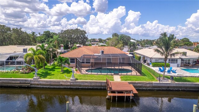 rear view of property with glass enclosure, a water view, and a patio