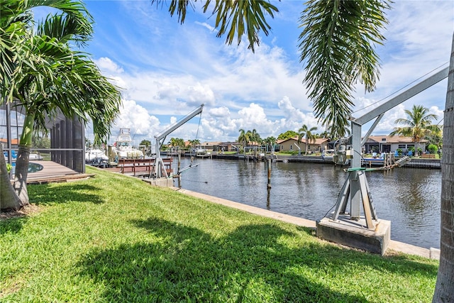 dock area with a yard and a water view