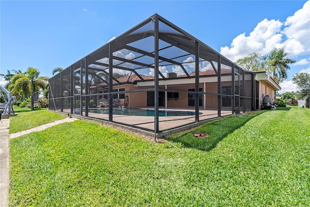 back of property featuring a lanai, a yard, and a patio