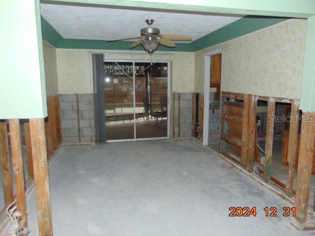 interior space with ceiling fan