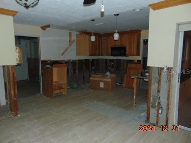 kitchen featuring kitchen peninsula, a center island, and hanging light fixtures