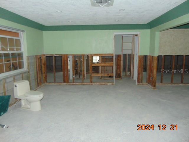 miscellaneous room with a textured ceiling