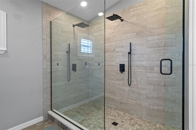 bathroom with a shower with door