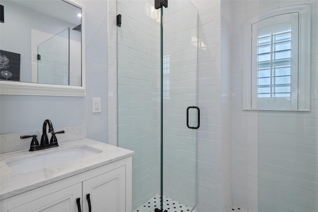 bathroom with vanity and a shower with shower door