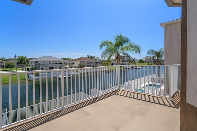 balcony with a pool and a water view