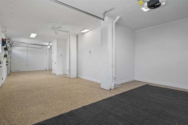 interior space featuring ceiling fan and a garage door opener