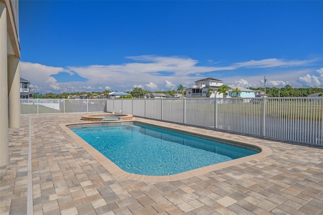 view of pool with an in ground hot tub and a patio