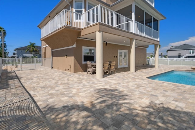 view of pool featuring a patio area and french doors