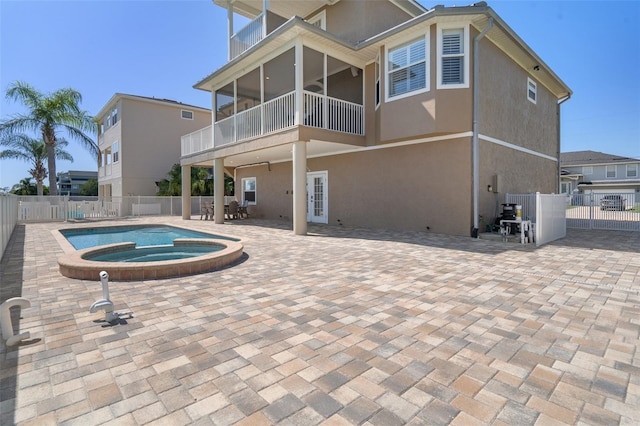 view of pool with an in ground hot tub and a patio