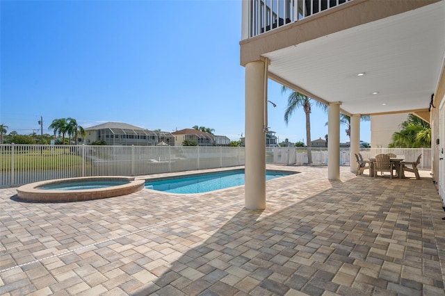 view of swimming pool featuring an in ground hot tub and a patio area