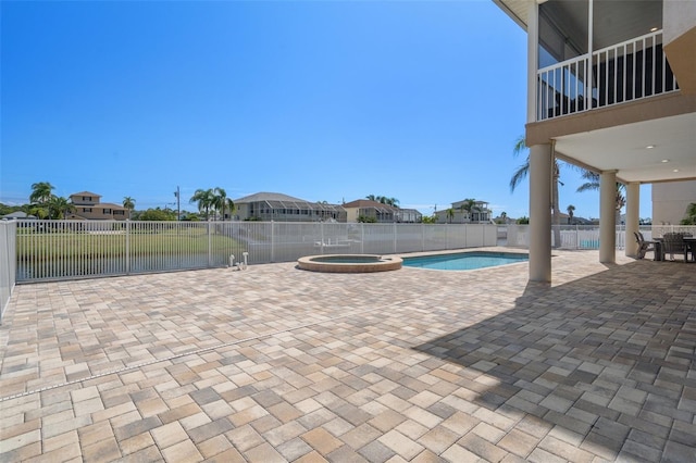 view of patio / terrace with a pool with hot tub