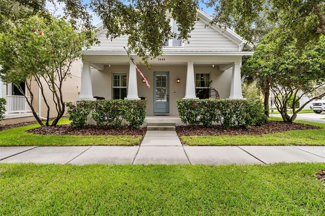 view of front facade with a front lawn and covered porch