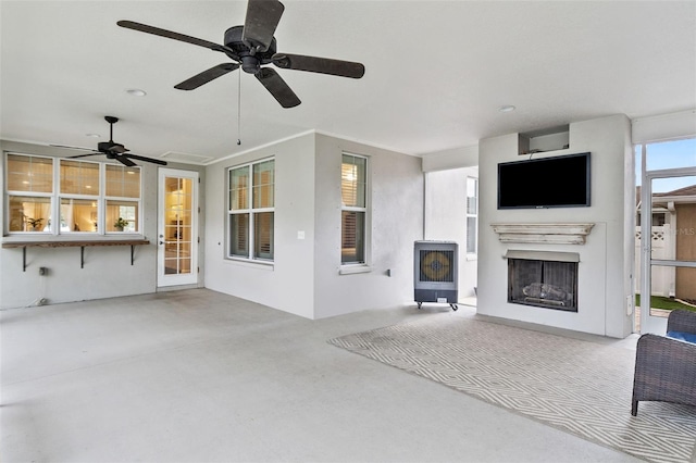 unfurnished living room featuring ceiling fan