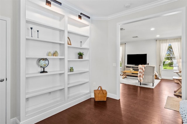 interior space with built in shelves, dark hardwood / wood-style floors, and crown molding