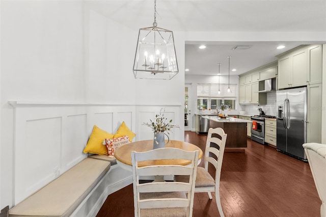 dining room featuring dark wood-type flooring and a chandelier