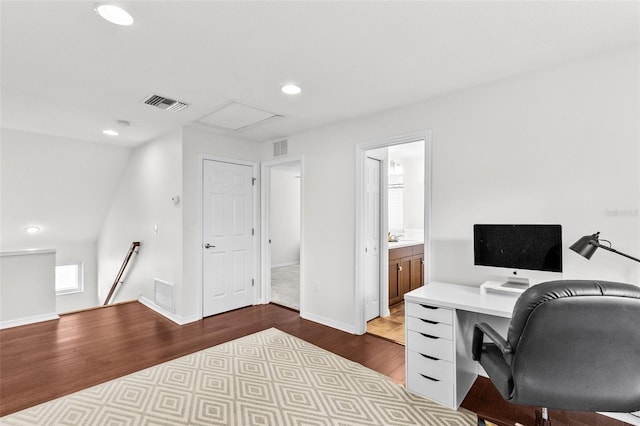 office space with light hardwood / wood-style floors and vaulted ceiling