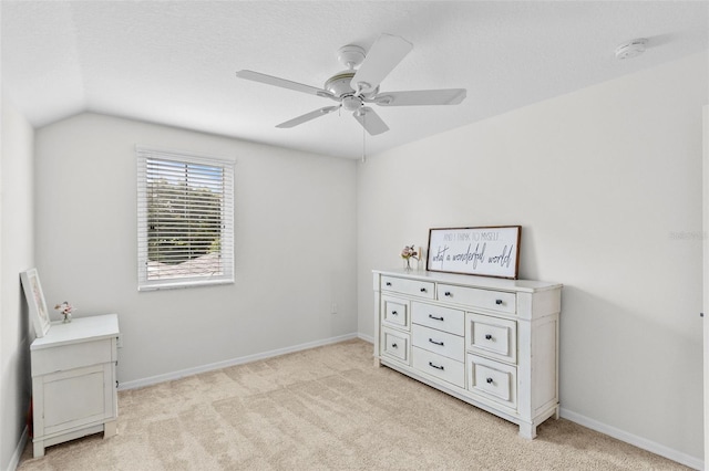 bedroom with a textured ceiling, light colored carpet, lofted ceiling, and ceiling fan