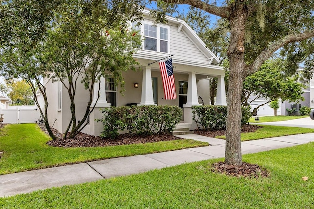 view of front facade with a front yard and covered porch