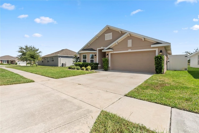 view of front of home featuring a front lawn and a garage