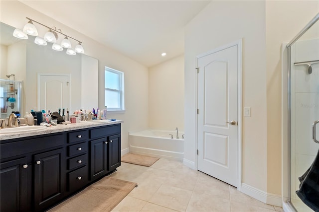 bathroom with tile patterned floors, independent shower and bath, and vanity