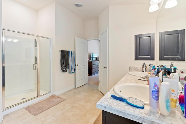 bathroom featuring vanity, an enclosed shower, and tile patterned floors