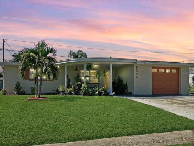 single story home with a yard and a garage