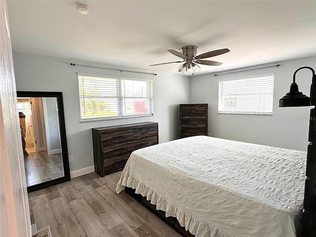 bedroom with ceiling fan and wood-type flooring