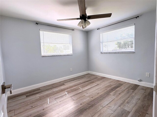 spare room with ceiling fan and wood-type flooring