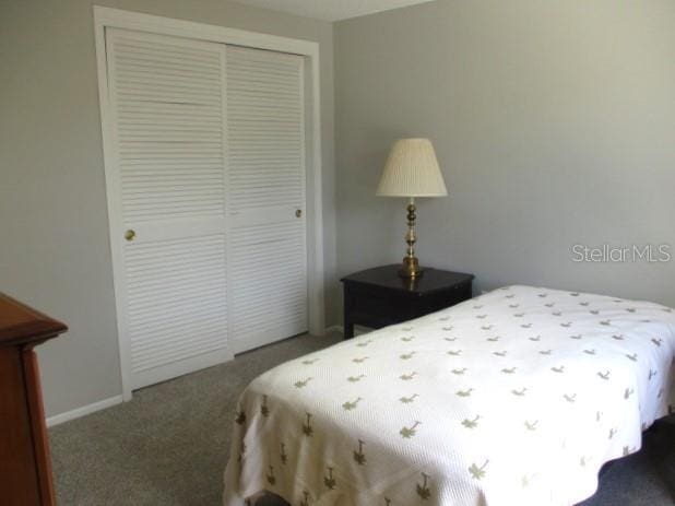 carpeted bedroom with a closet