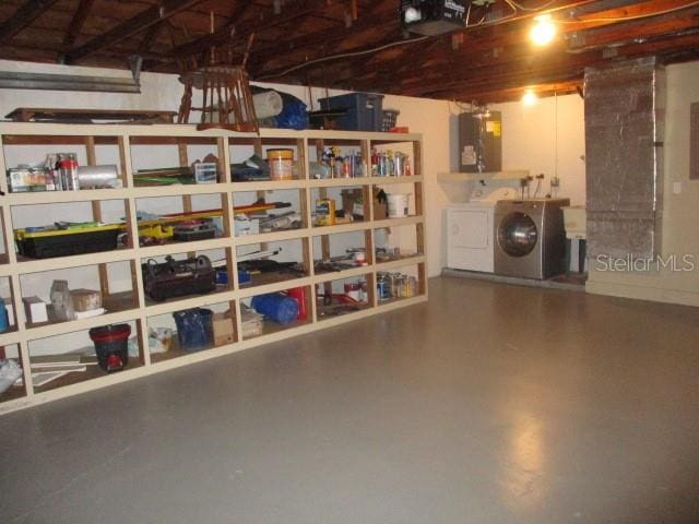 interior space featuring a garage door opener, water heater, and separate washer and dryer