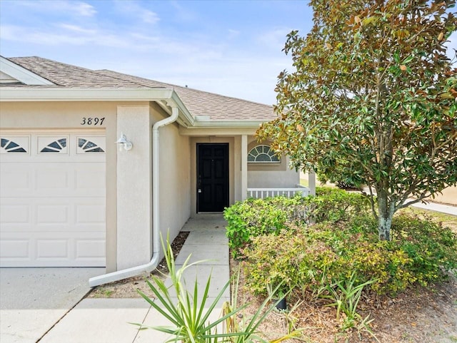 view of exterior entry featuring a garage