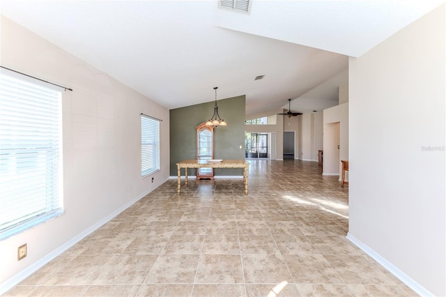 interior space with tile patterned flooring, vaulted ceiling, and a chandelier