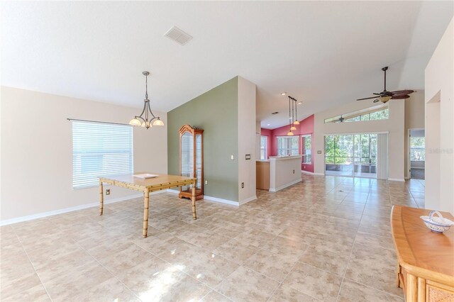 interior space featuring light tile patterned floors, ceiling fan with notable chandelier, vaulted ceiling, and decorative light fixtures