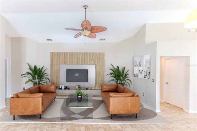 living room with a ceiling fan, baseboards, and visible vents