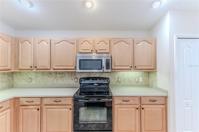 kitchen with light countertops, tasteful backsplash, stainless steel microwave, black range with electric cooktop, and light brown cabinets