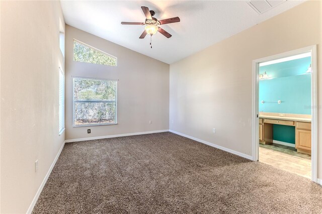 carpeted empty room featuring ceiling fan and lofted ceiling