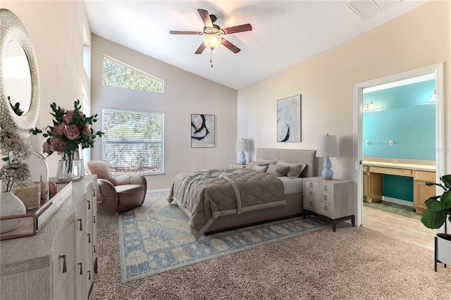 bedroom with light carpet, connected bathroom, vaulted ceiling, and visible vents
