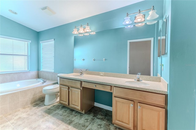 bathroom featuring tiled bath, vaulted ceiling, vanity, tile patterned flooring, and toilet